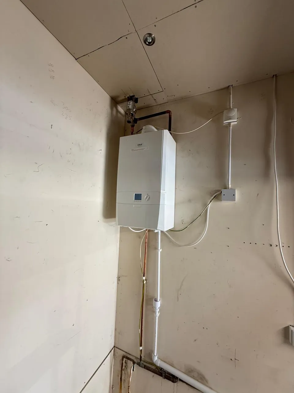 Ideal boiler replacement completed in a cupboard with tidy pipework and controls