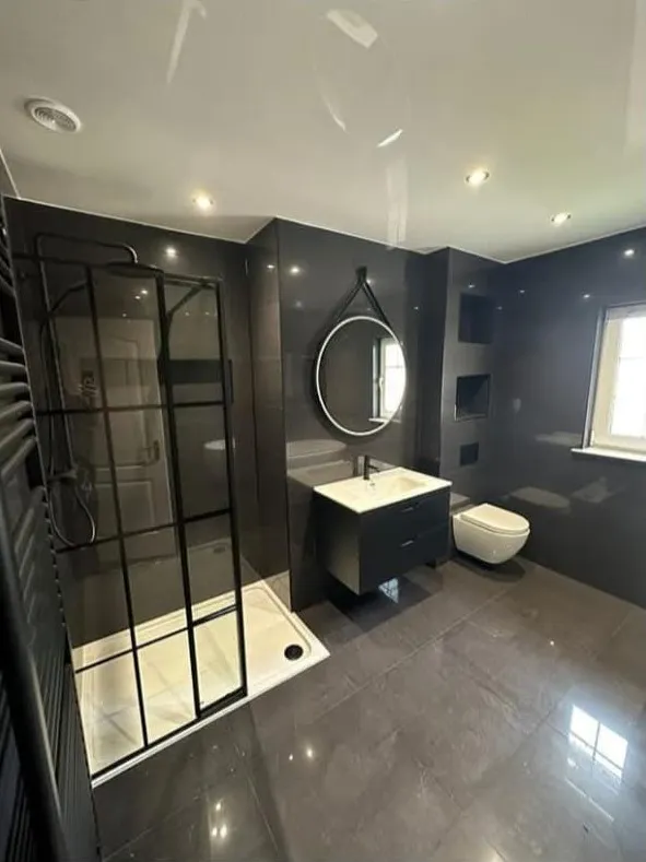 Bathroom Fitting in Kirkcaldy and Fife: Bathroom fitting in Fife: dark tiled bathroom with crittall-style walk-in shower, wall-hung vanity and round mirror