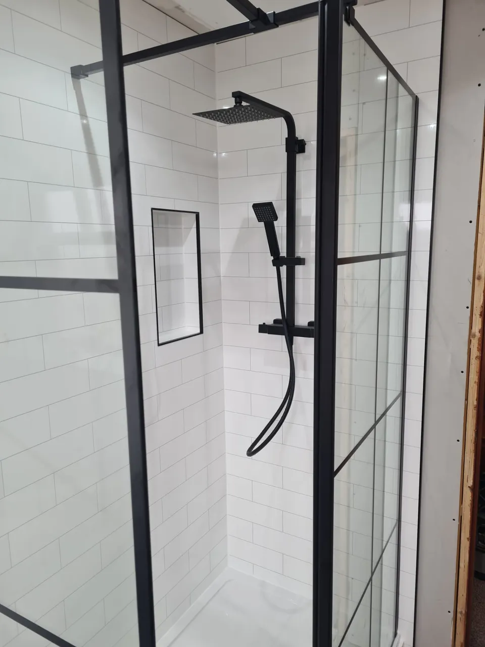 Emergency Plumbing & Heating in Kirkcaldy and Fife: Black rain shower and grid shower screen with recessed niche during bathroom installation