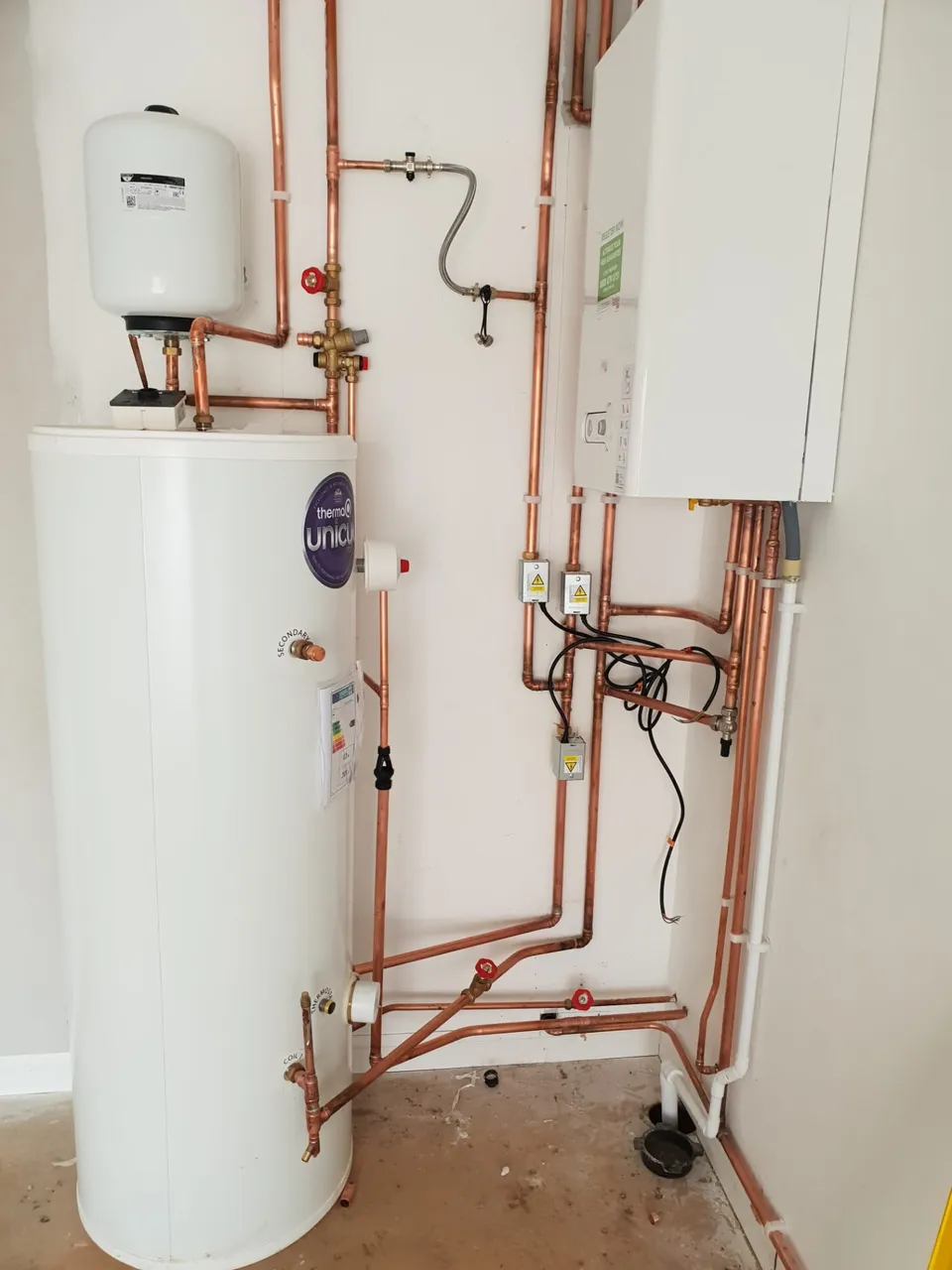 Unvented Hot Water Cylinders in Kirkcaldy and Fife: Unvented hot water cylinder installation with expansion vessel, system boiler and zone valves